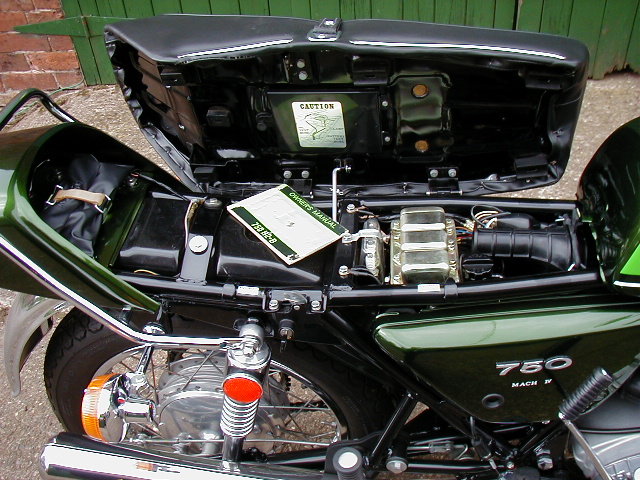 1975 Kawasaki H2B 750 - under seat detail including spare plug holder, tool kit and hand book. 
